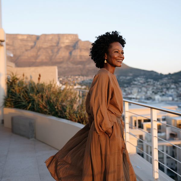Elegant Black woman enjoying wine and mountain views in South Africa's Cape Winelands